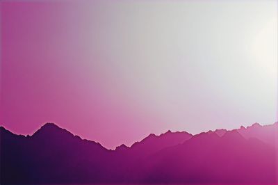 Scenic view of silhouette mountains against clear sky