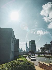 Low angle view of buildings against sky on sunny day