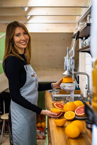 Portrait of smiling woman at kitchen