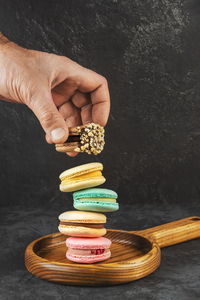 Macaroons stacked on a dark background. delicious french cuisine