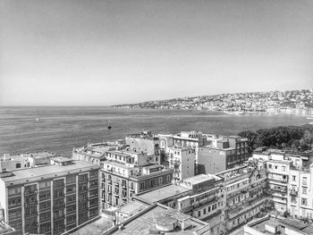 High angle view of buildings by sea against sky