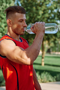 Side view of man drinking water
