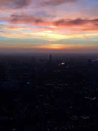 Aerial view of city against sky at sunset
