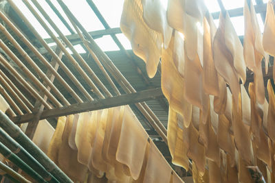 Low angle view of clothes hanging on metal for sale