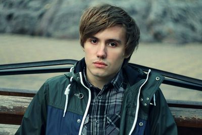 Portrait of serious young man on bench