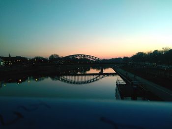 Scenic view of river against clear sky at sunset