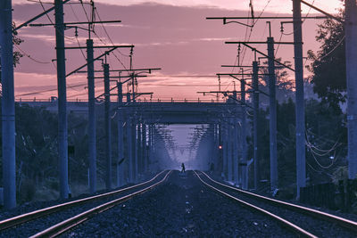 Railroad tracks against sky during sunrise