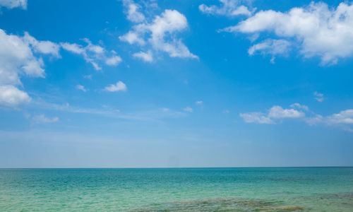 Scenic view of sea against the blue sky. white fluffy clouds in blue sky sunny summer season