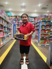 Portrait of smiling boy standing in store