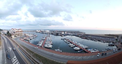 High angle view of city by sea against sky