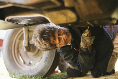 Woman repairing tractor