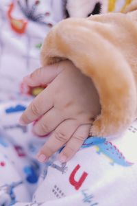 Close-up of baby sleeping on bed