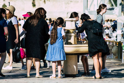 Group of people standing against the wall