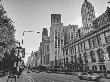 City street and buildings against sky