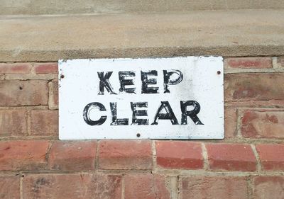 Close-up of text on brick wall