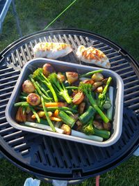 High angle view of meat in barbecue grill