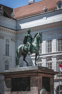 Low angle view of statue against building