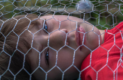 Close-up of a ball on chainlink fence