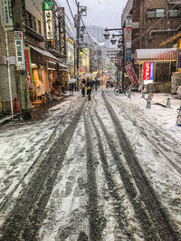 Railroad tracks in city during winter