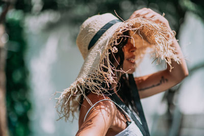 Close-up portrait of woman wearing hat