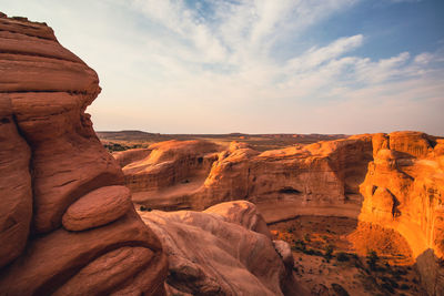 Scenic view of rock formations against cloudy sky