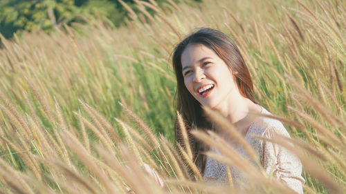 Portrait of smiling young woman on field