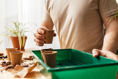 Midsection of man working on table