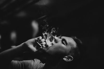 Close-up of young man smoking cigarette