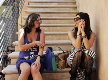 Cheerful woman sitting on steps