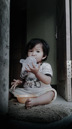 Portrait of cute girl sitting at home