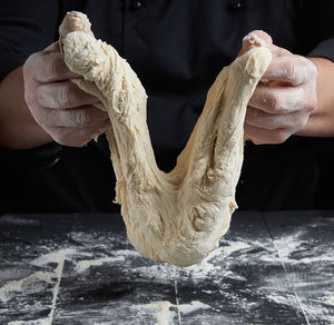 Midsection of chef preparing food at table