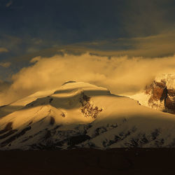 Scenic view of snowcapped mountains against sky during sunset