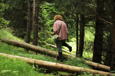 Rear view of man walking in forest