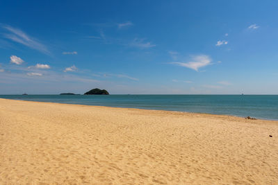 Scenic view of beach against blue sky