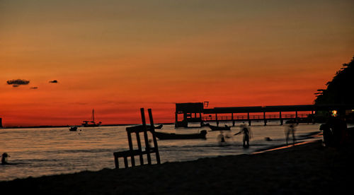 Scenic view of sea against orange sky