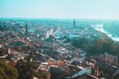 Blue hours in verona city centre, italy. panoramic view from above on streets and adige river