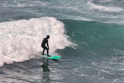 Full length of man surfing in sea