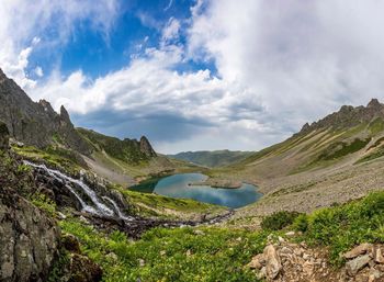 Scenic view of lake and mountains against sky