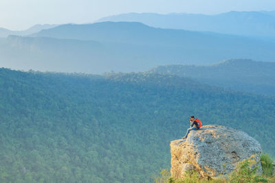 Man on mountain against sky