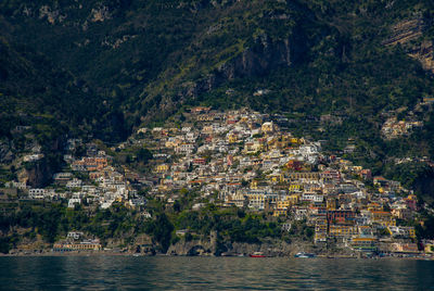 April 15 2022-amalfi coast italy photographed from the ferryboat on a sunny day with colorful houses 