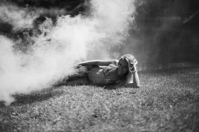 Woman lying down on field