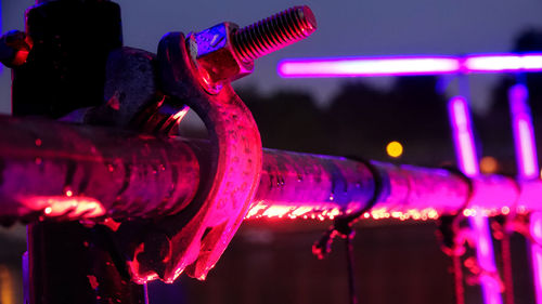 Close-up view of illuminated machine at night