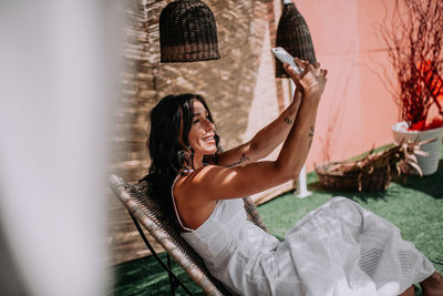 Young woman smiling while sitting outdoors