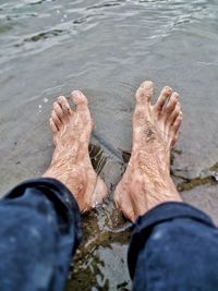 Low section of man legs in water