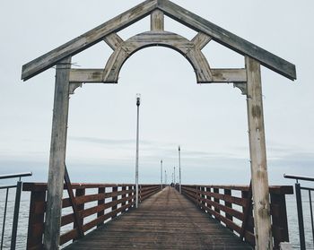 Pier over sea against clear sky