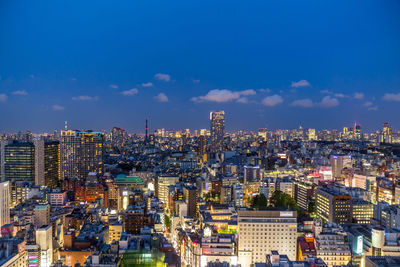 Illuminated cityscape against sky