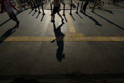 Low section of people walking on street