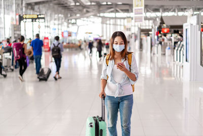 Full length portrait of woman walking in corridor