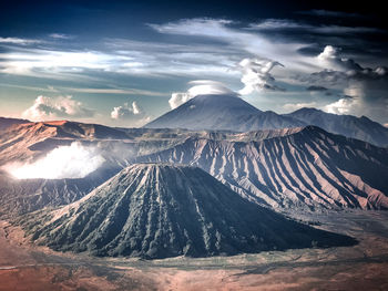 Panoramic view of volcanic landscape against cloudy sky