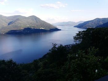 Scenic view of sea and mountains against sky